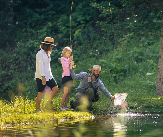 A mom and daughter fly-fishing with a Little Nell Adventure Guide.