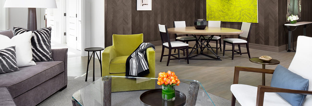 The Pfeifer suite's livingroom featuring sleek designs and a dining table and chair set.
