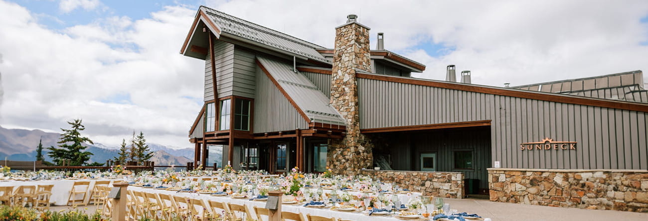 The Sundeck on top of Aspen Mountain with banquet style tables set on the patio.