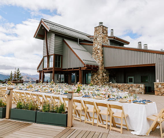 The Sundeck on top of Aspen Mountain with banquet style tables set on the patio.