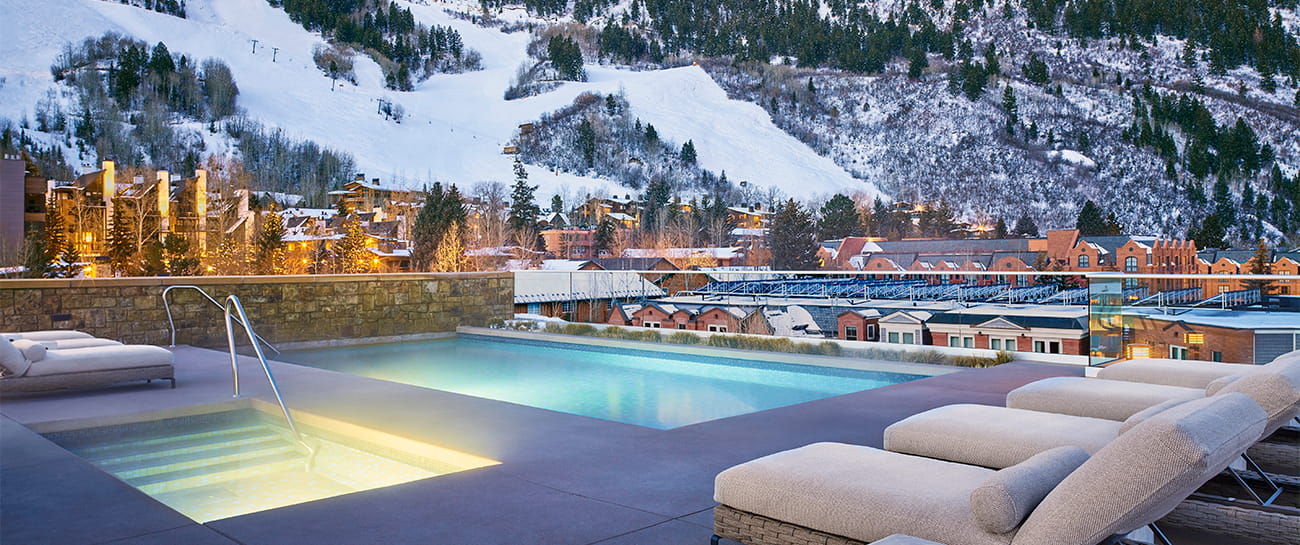 The rooftop pool at the Residences with snowy mountain slopes in the background