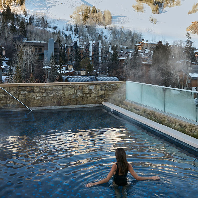 woman in RLN pool overlooking aspen mountain