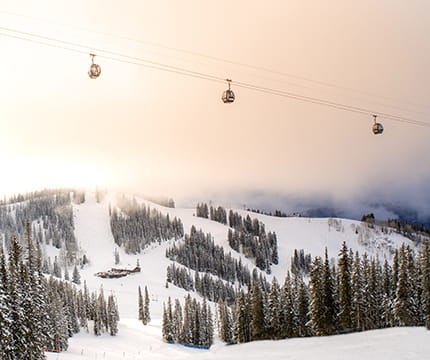 Gondolas above Aspen Mountain at sunrise.