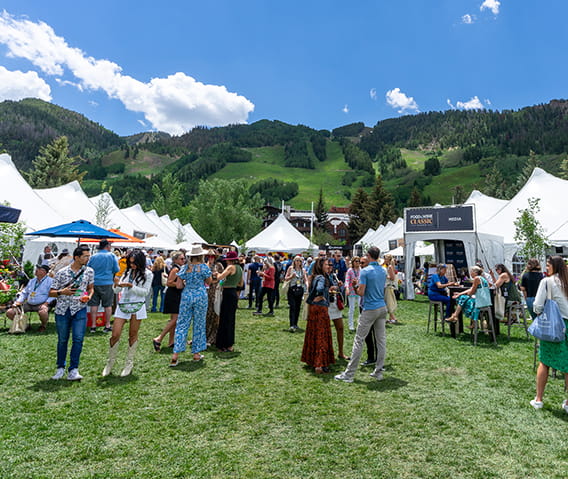 People walking around inside the Food & Wine in Aspen Grand Pavilion.