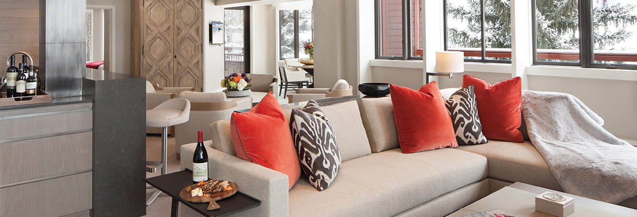 Cozy lounge area with plush seating and pillows in The Little Nell Suite in Aspen.