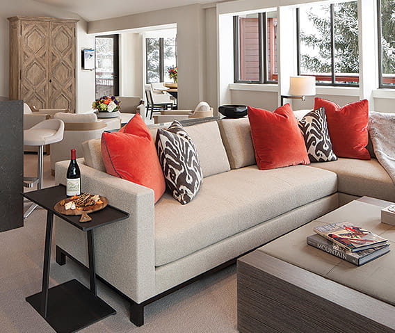 Cozy lounge area with plush seating and pillows in The Little Nell Suite in Aspen.