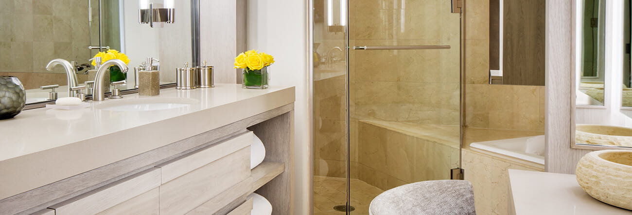 Luxurious bathroom with dual vanities, soaking tub, and steam shower in The Paepcke Suite.