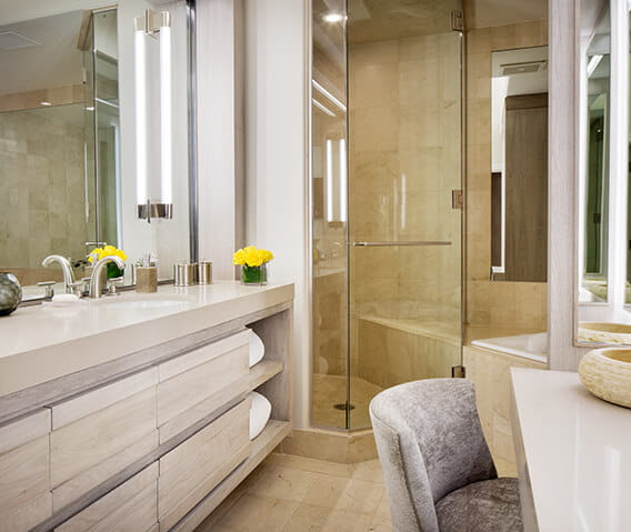 Luxurious bathroom with dual vanities, soaking tub, and steam shower in The Paepcke Suite.