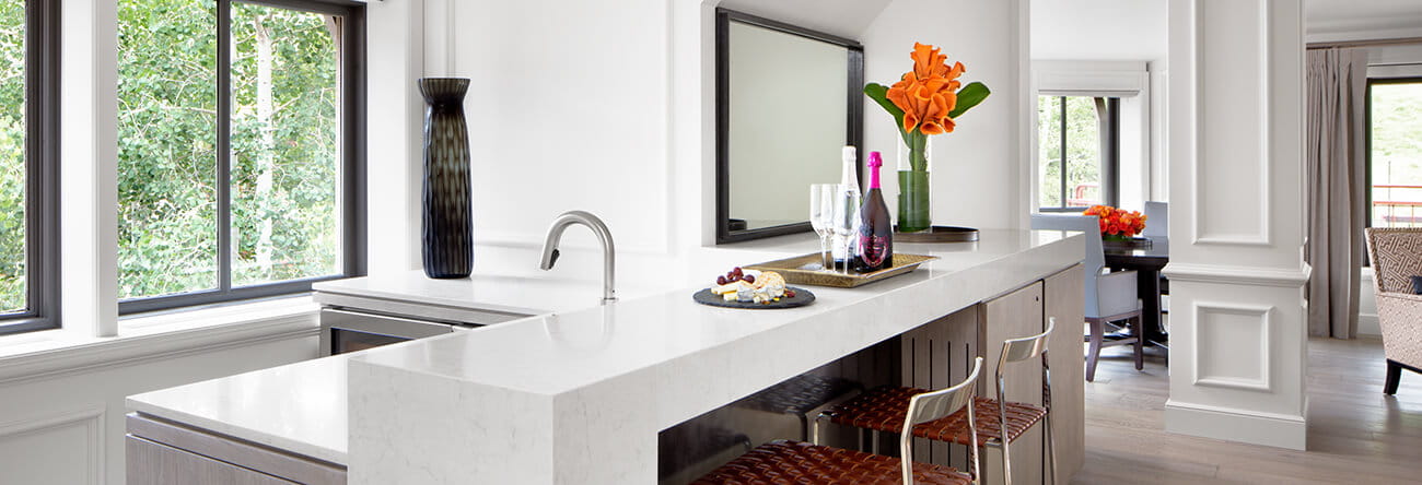 A bar with wine and cheese inside the Paepcke Suite at The Little Nell.