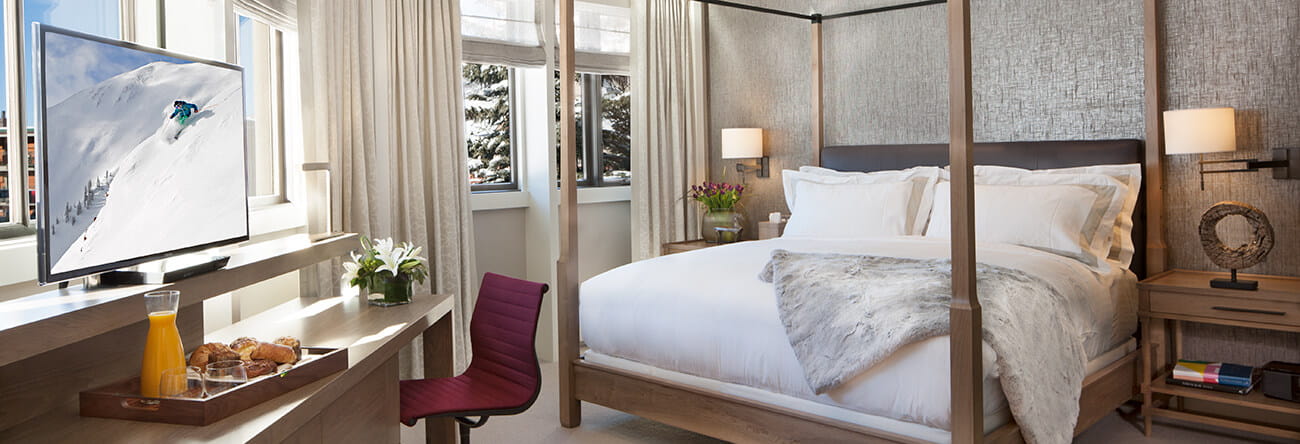 The Pfeifer suite's master bedroom featuring a king-sized bed and flatscreen.