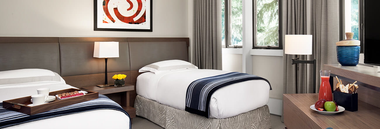 Two twin beds in the second bedroom of the Pfeifer Suite at The Little Nell in Aspen.