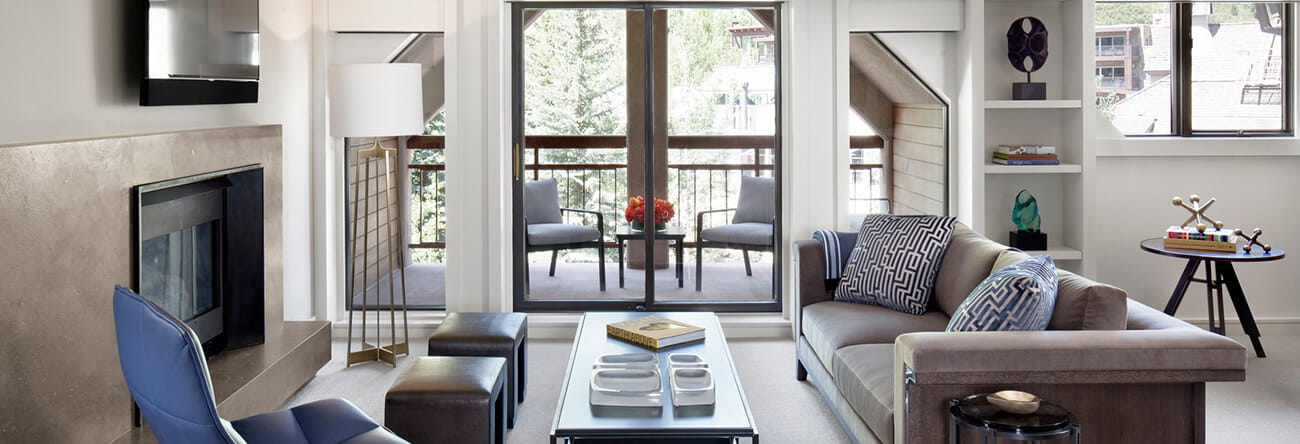 The elegant living room and private balcony of the Roch Suite.