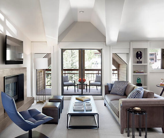 The elegant living room and private balcony of the Roch Suite.