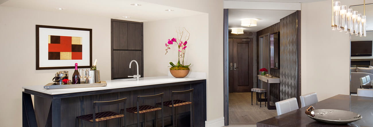 The Iselin Suite's fully stocked bar and spacious entryway.