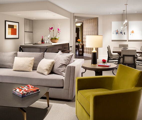 The Benedict suite's spacious living room featuring ample seating and unique artwork.