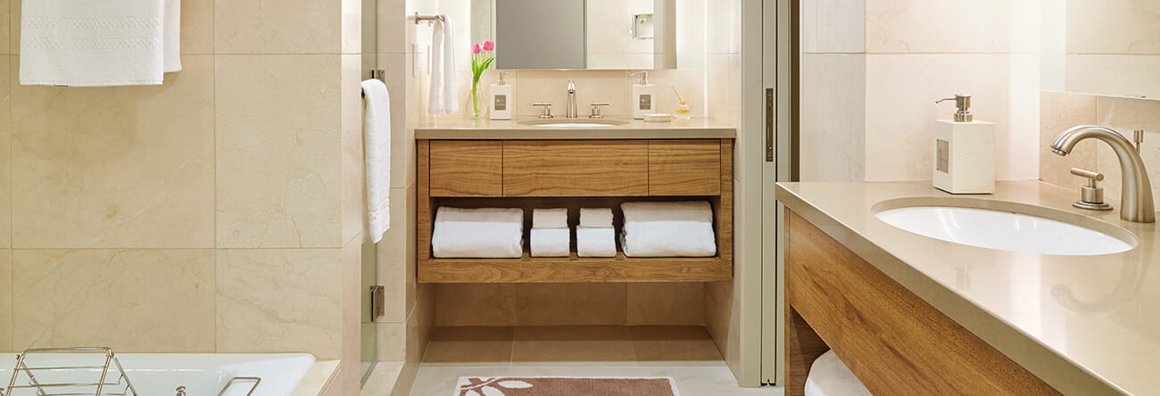 Stone vanities, a soaking tub, and a shower in the luxury guest room bathrooms.