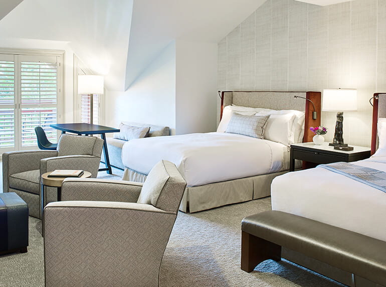 a room with two beds and a table