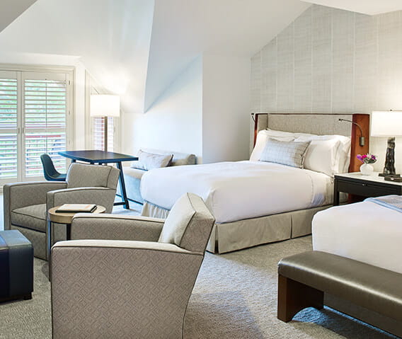 Premium mountain side guest bedroom at The Little Nell with two twin beds and a balcony.