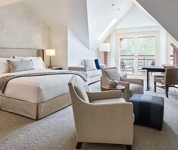 The Premium Townside Guestroom's spacious master bedroom featuring a gas-burning fireplace and balcony.