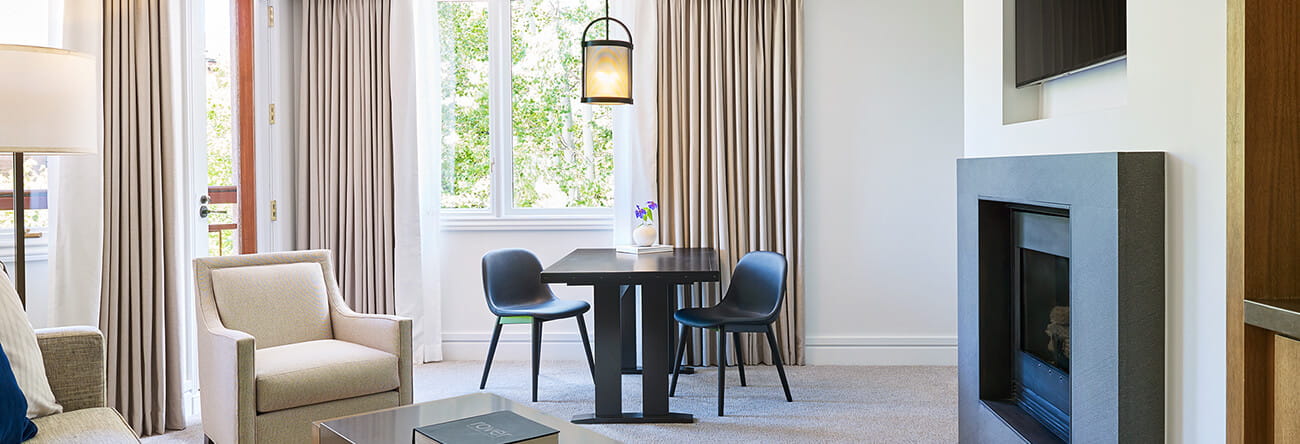 Gas log fireplace and seating in the luxury one bedroom town side suite.