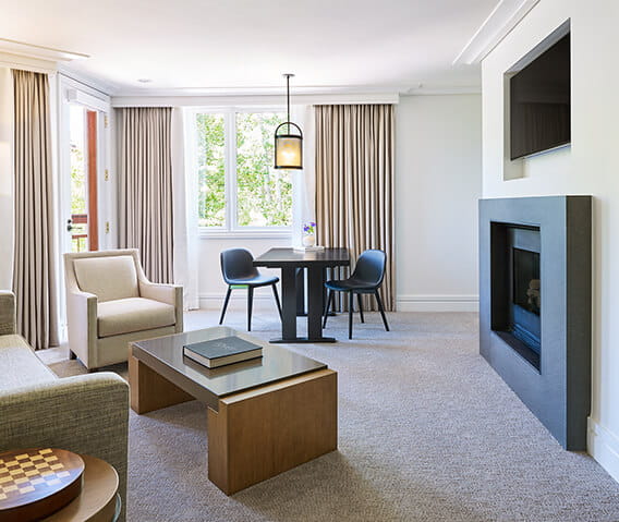 Gas log fireplace and seating in the luxury one bedroom town side suite.