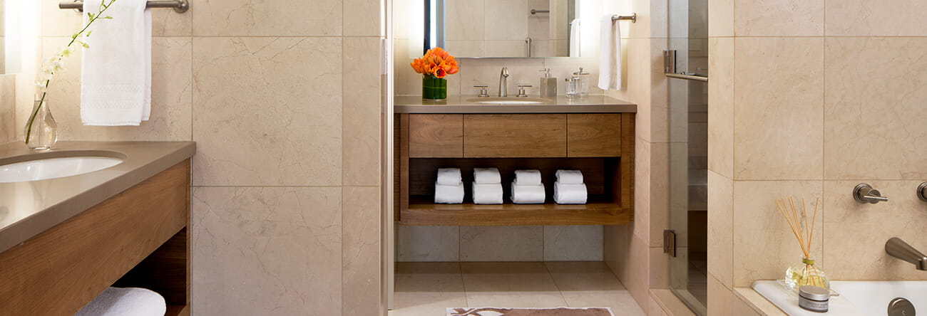 The Pfeifer suite's elegant bathroom featuring a steam shower and Jacuzzi® soaking tub.