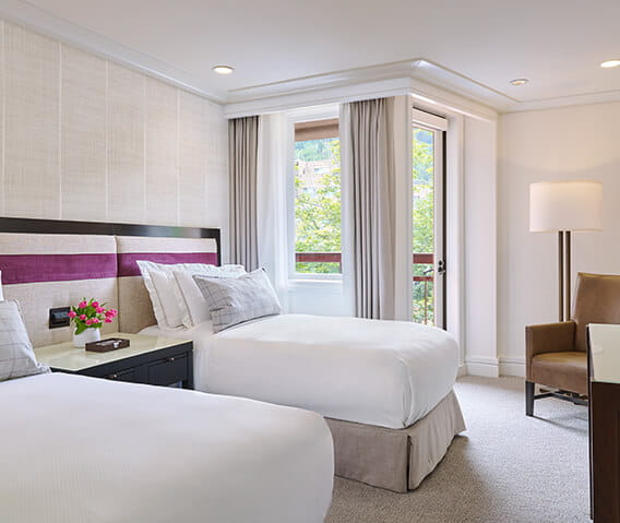 A two bedroom town side suite at a luxury 5 star hotel in Aspen, featuring two twin beds.