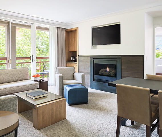 Two bedroom town side suite with a fireplace and dining table for four.