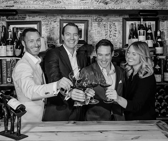 The Little Nell team of sommeliers toasting in The Wine Cellar.