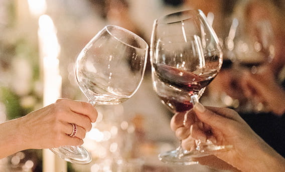 Guests at The Little Nell enjoy the award-winning wine program with glasses of red and white wine.