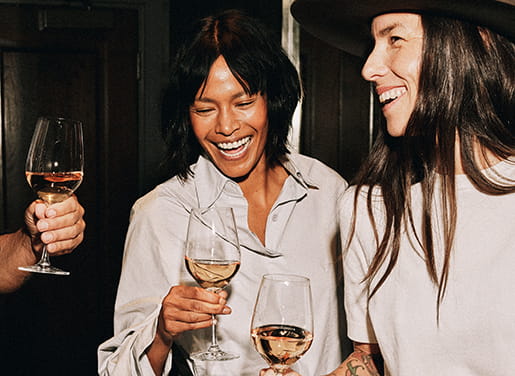 friends drinking wine and laughing