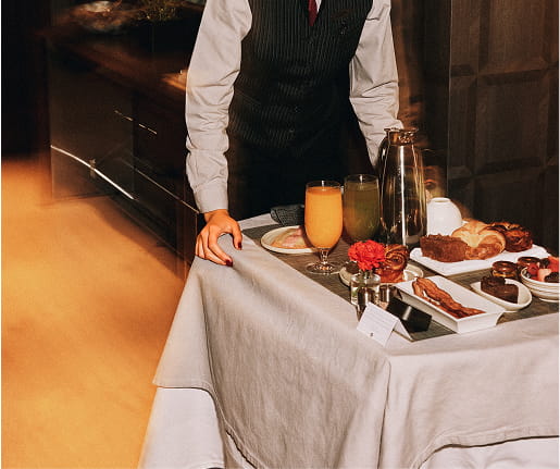 staff taking in room dining food into room