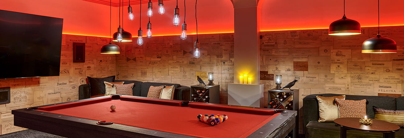 Aspen speakeasy bar with flatscreen TVs and a pool table.
