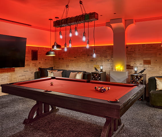 Aspen speakeasy bar with flatscreen TVs and a pool table.