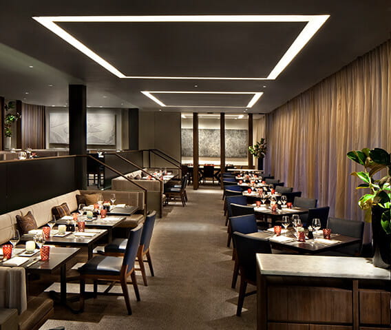 Table settings with wine and candles at fine dining Aspen restaurant.