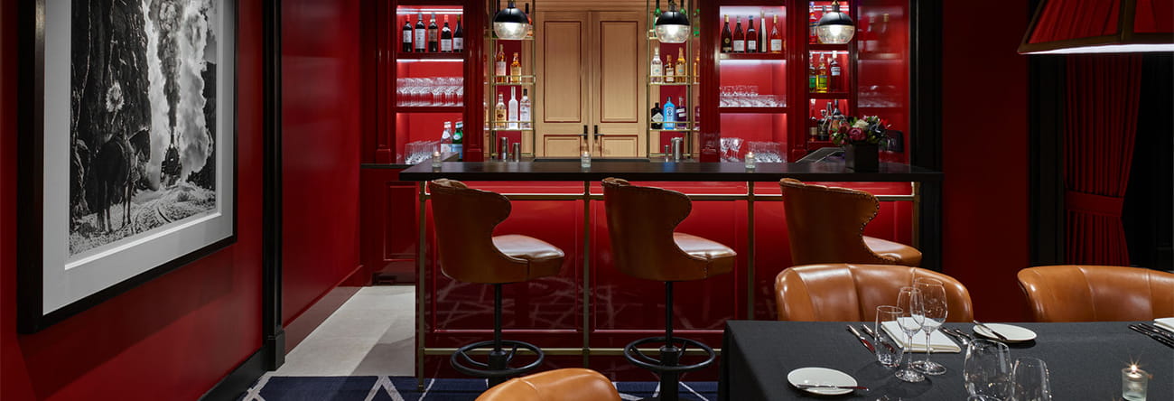 The Board Room, a hidden speakeasy with table set for dinner and a private bar.