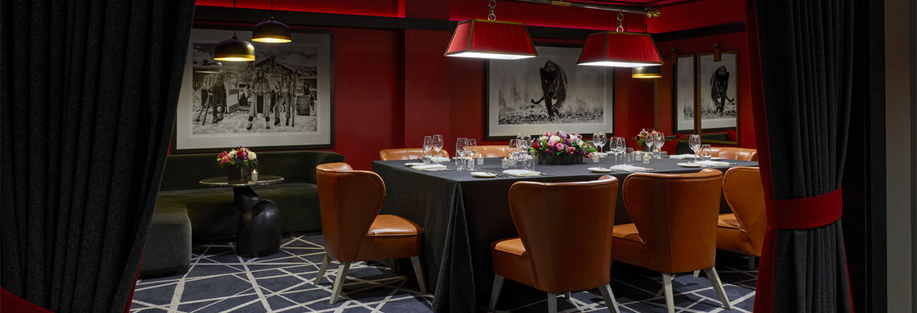 The Board Room, a hidden speakeasy private room set for dinner.