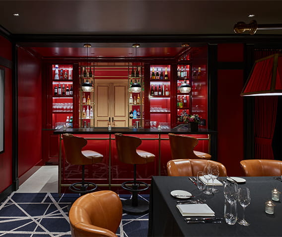 The Board Room, a hidden speakeasy with table set for dinner and a private bar.