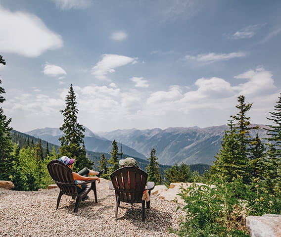 two women sitting looking out on Aspen Mountain 