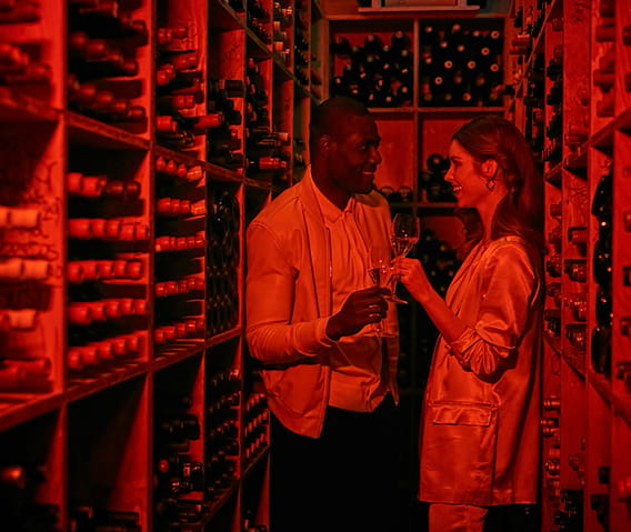 Two guests enjoy a private wine tasting in The Little Nell's wine cellar.