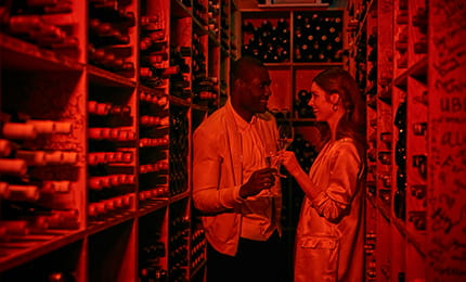 Two guests enjoy a private wine tasting in The Little Nell's wine cellar.