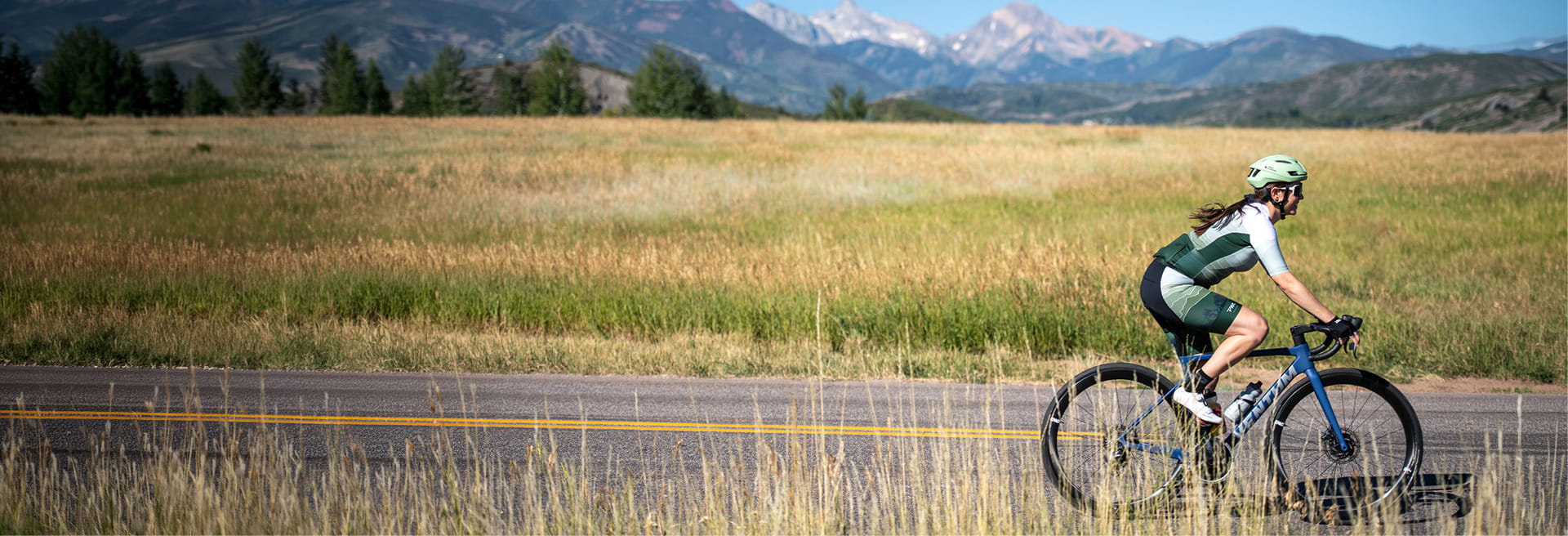 women riding bike in mountains