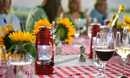 Sunflowers and wine on a checkered table