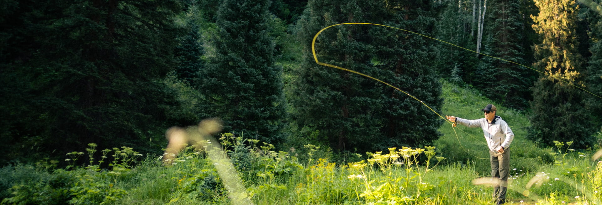 man fly fishing in the mountains
