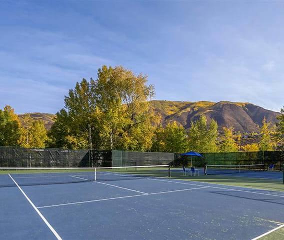 Tennis courts in Aspen with stunning mountain ranges surrounding.