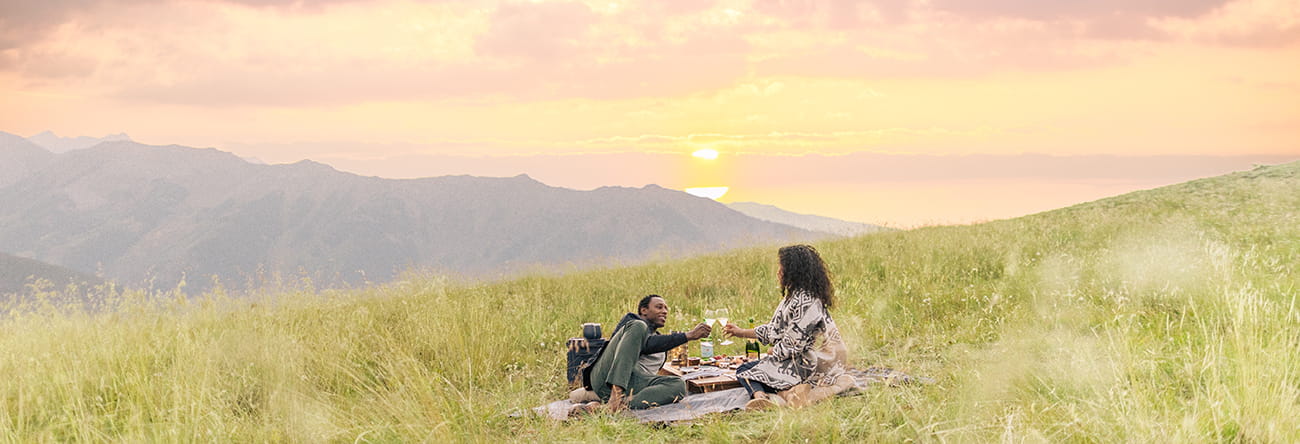 a couple enjoying a picnic on aspen mountain at sunset 