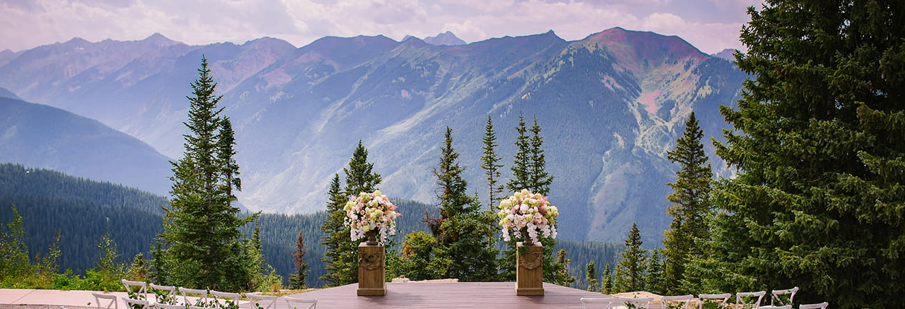 The Aspen Mountain Wedding Deck is The Little Nell's premier summer wedding ceremony venue, offering stunning views of the Elk Mountain Range.