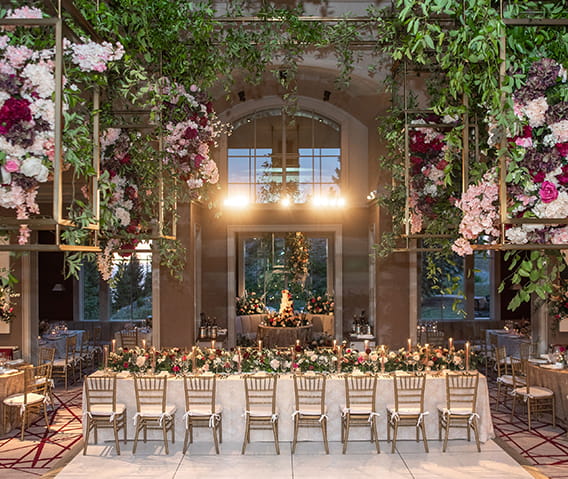 The ASPENX Mountain Club decorated with a greenery and flowers for a banquet style dinner.