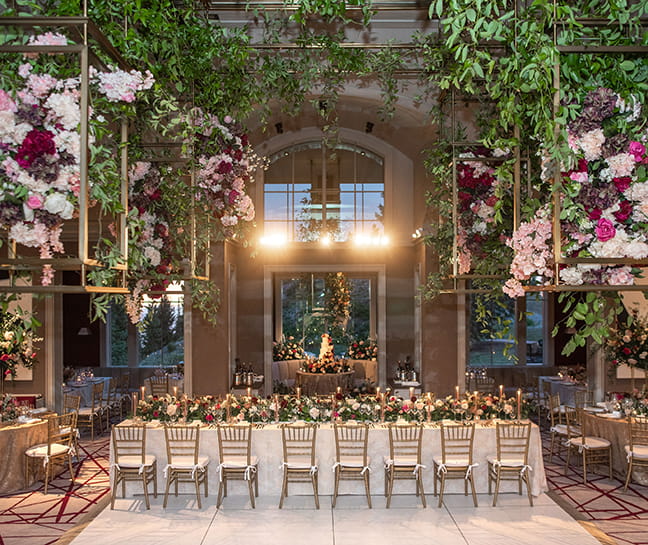 The ASPENX Mountain Club decorated with a greenery and flowers for a banquet style dinner.