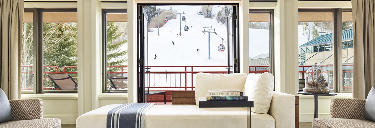 a window with a chair and a view of the snow